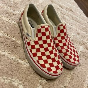 Red and off white checkerboard slip on vans